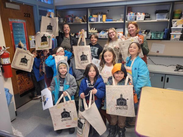 Group of children holding their custom screen print bags they created