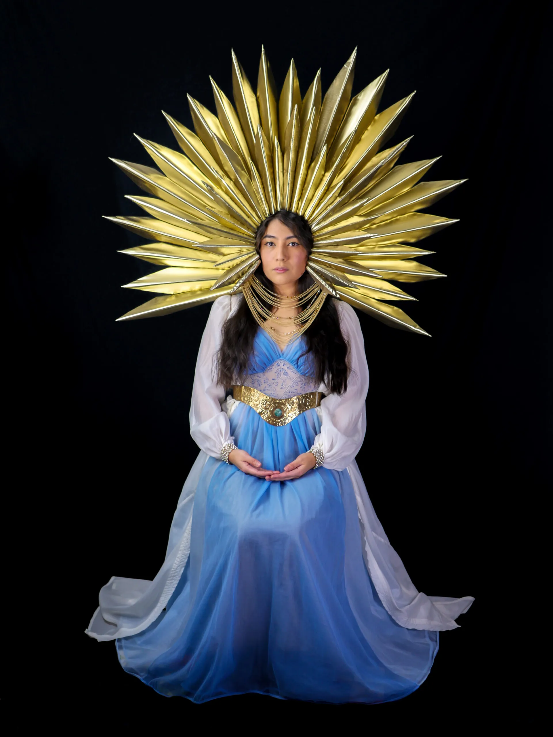 girl in blue dress with gold headpiece