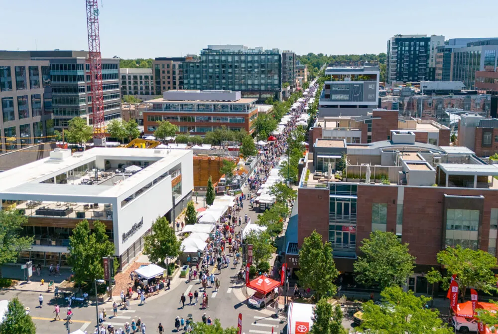 Photo of a festival crowd and surrounding buildings from a drone above