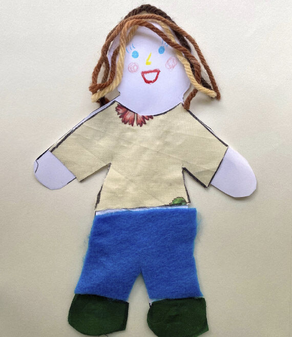 Handmade doll out of paper, glue and yarn