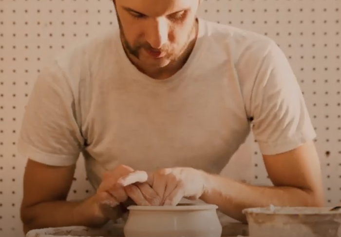 man creating ceramics on a wheel